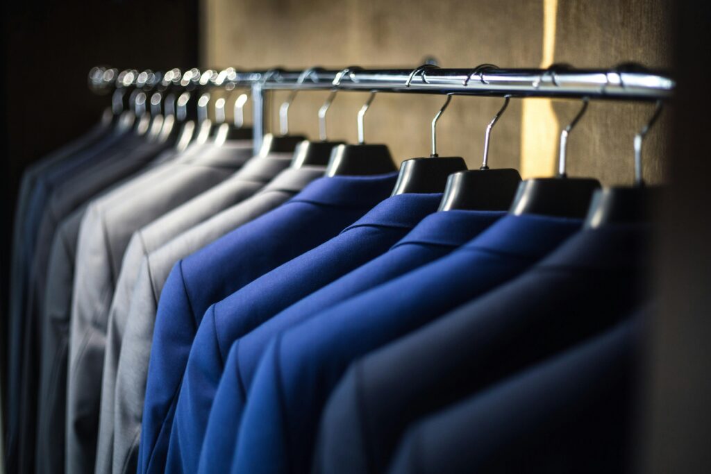 Which Company Is Best for Clothes? A Complete Guide for Shoppers Close-up of neatly arranged suits in a wardrobe, showcasing fashion and organization.